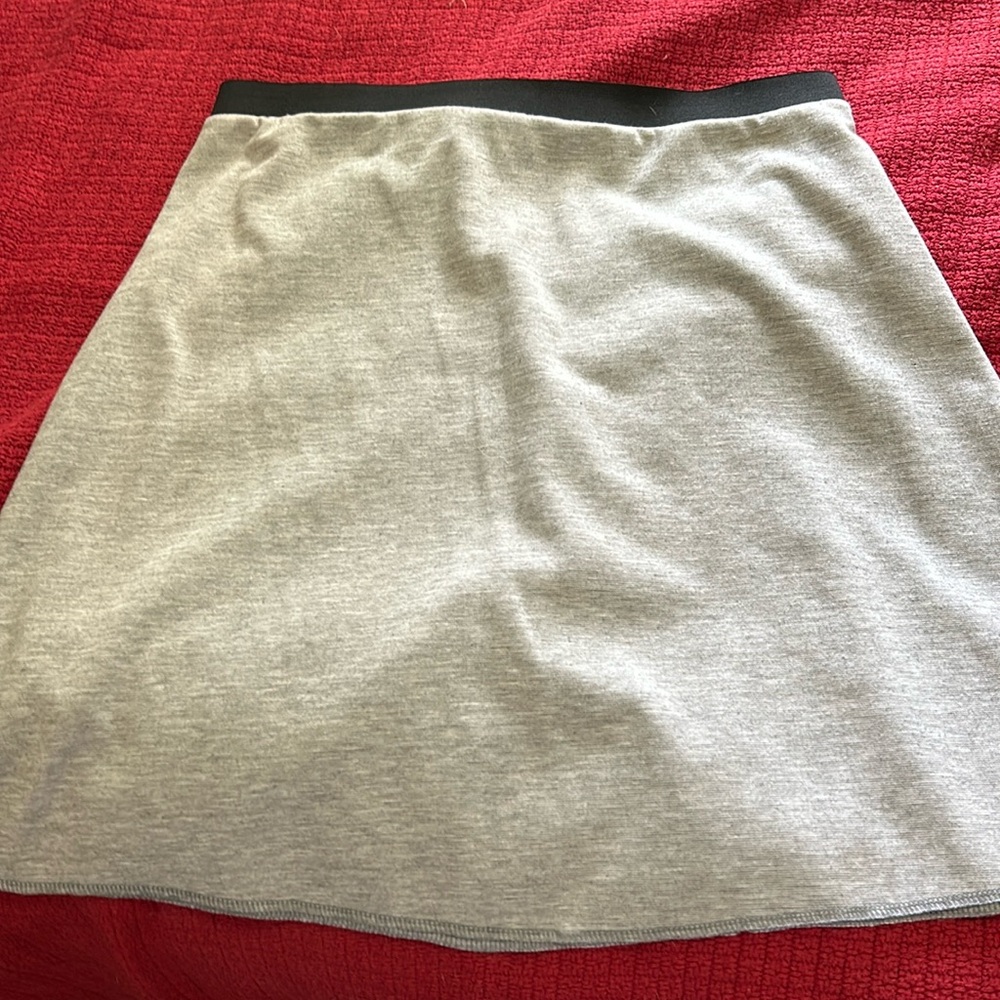 Grey skirt with black elastic band, falls right above knee